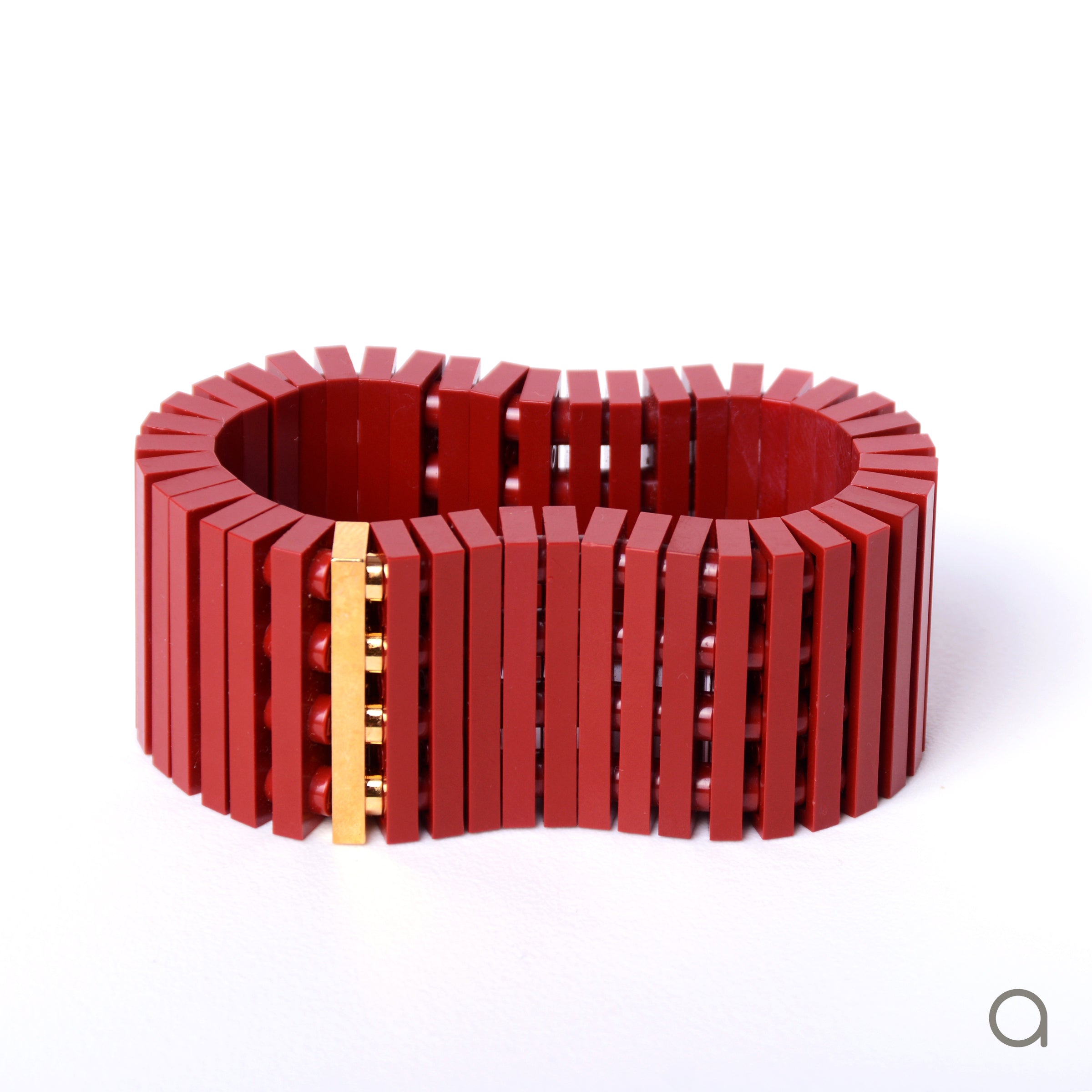 Dark red striped bracelet with goldplated brick